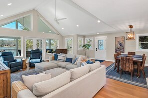 Great room with double doors that lead out to screened-in porch