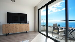 Relax in style at Meeresbrise by LovelyStay, featuring a modern living area with a smart TV and a balcony offering breathtaking ocean views—perfect for unwinding in tranquility.#balcony#sun