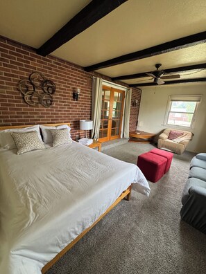 Spacious bedroom with double bed, sitting area, new carpet & natural light.