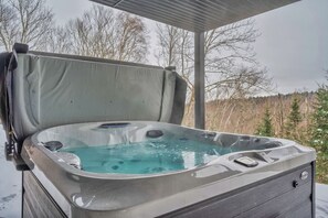 Enjoy a soothing soak in the private hot tub, perfect for ultimate relaxation!