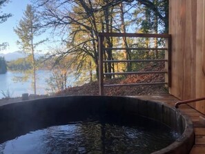 Cedar soaking tub attached to Lodge faces west with lake and mountain view.