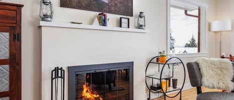 Wood fireplace in the main living room, with a Samsung Frame TV.