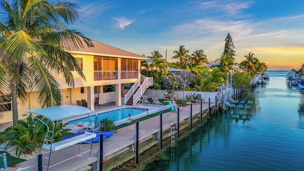 Paradise Palms - A peaceful waterfront retreat with private dock, heated pool, and breathtaking sunset views — the perfect blend of luxury and coastal charm.
