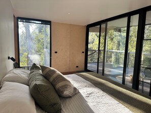 Beautiful forest views from the bedroom and a hot outdoor shower on the deck