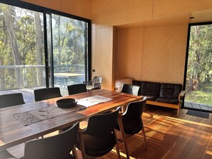 Huge timber dining table comfortably seats 8 people.