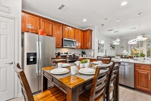 Gather around this welcoming dining space, perfect for shared meals and good conversations - Fully equipped kitchen with stainless steel appliances makes cooking effortless - Warm wood tones and modern lighting create a cozy and inviting atmosphere