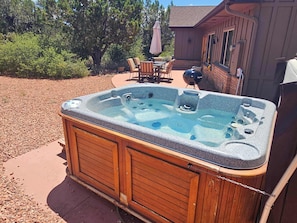 Relax in the outdoor hot tub, nestled in the backyard patio.