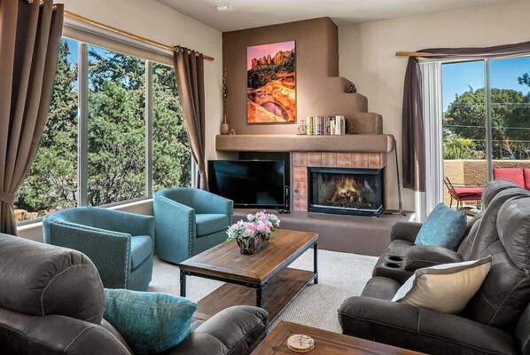 Charming living room with fireplace and desert views from the windows or balcony!