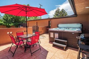 Outdoor space with hot tub and grill