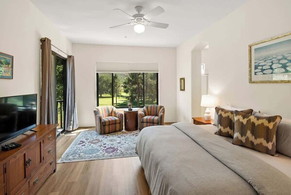 King suite bedroom with private full bathroom and patio access.