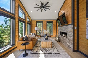 Black accents, luxurious leather couch, tasteful design -- all come together.
