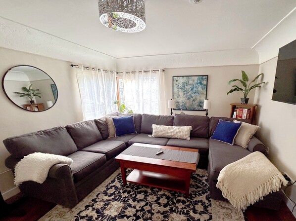 Living room space. The coffee table raises and opens to a large game/dining tabl