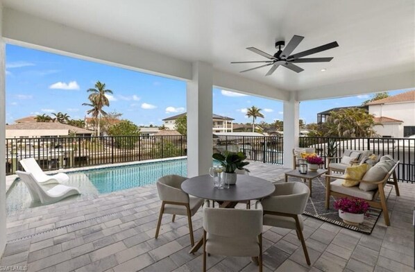 Dine poolside under the shade—your private outdoor oasis awaits
