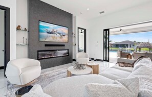 Open Concept Floor Plan with Electric Fire Entertainment Center and Smart TV.