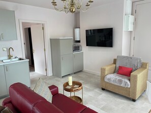 Bright open plan living with smart TV, free WiFi, work table, luxury bed-settee,  fully equipped kitchen. View across the lake .