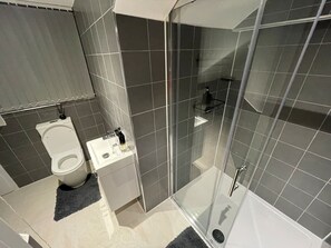 The bathroom combines style and functionality, providing a pleasant space to unwind.