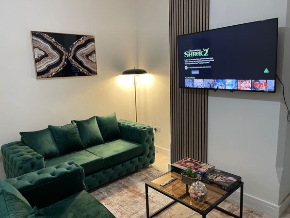 The living room features a stylish sofa and TV, creating a cosy and aesthetically pleasing space to relax and unwind.
