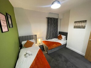 Featuring two single beds, this bedroom is perfect for friends or family members staying together.