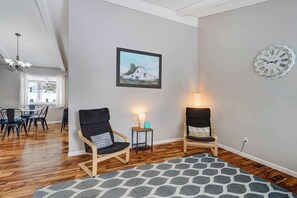 This inviting nook seamlessly connects to the dining area, creating an open and airy feel. A perfect spot to enjoy a quiet conversation or unwind after a long day..


