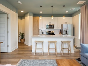 Living room with a sleep sofa and a fully equipped kitchen.