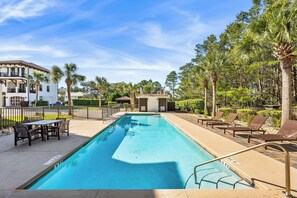 Shared pool with al fresco dining and lounge chairs.