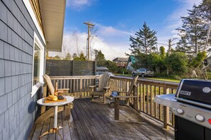 Deck with seating and a grill.