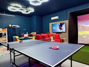 Full size ping pong table in the game room along with skeeball, arcades, basketball games, golf simulator, baby games, 3 beds, sofa, move theater, bathhroom, golf simulator, golf clubs, putting green, refrigerator and kichenett!