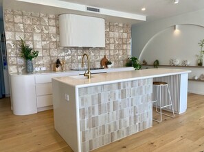 Designer kitchen the centrepiece of entertainment to the dining and lounge.