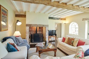 The sitting room with its inglenook fireplace has plenty of space for 6