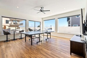 Game room with ping pong table, and TV