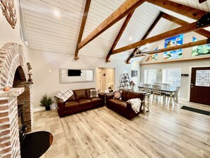 Brick fireplace (wood burning stove), large living room, beautiful wood beams.