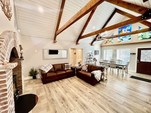 Brick fireplace (wood burning stove), large living room, beautiful wood beams.