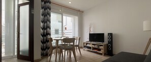 Living-dining room with balcony and TV area