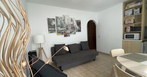 Living-dining room with sofa bed and modern decor