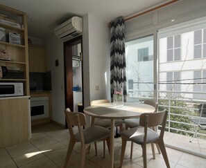 Dining area with balcony and integrated kitchen