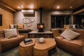 Cosy lounge with two single day/beds to relax by the fire. 