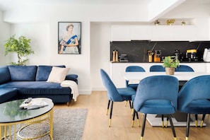 Stylish, spacious lounge with 65" Smart TV and air conditioning for comfort.
