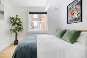 Bedroom 2 with double bed and full air conditioning for a cool, restful stay.