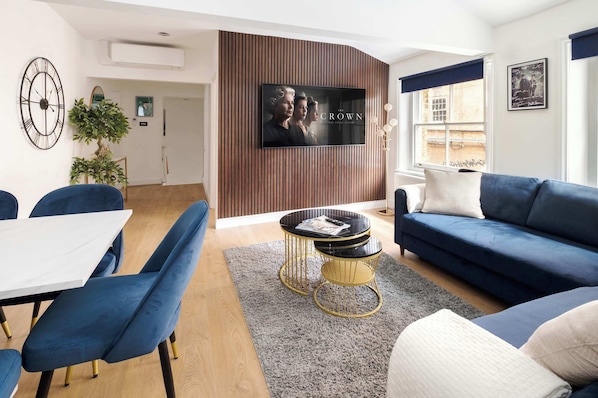 Stylish, spacious lounge with 65" Smart TV and air conditioning for comfort.