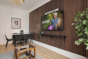 Luxury lounge with high ceilings, 70" TV, A/C & chic Victorian design.