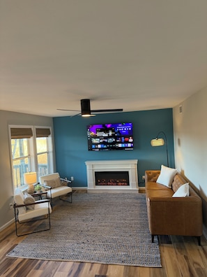 Living room. Couch faces Kitty Hawk Bay. 65in smart tv with Spectrum Tv set up.