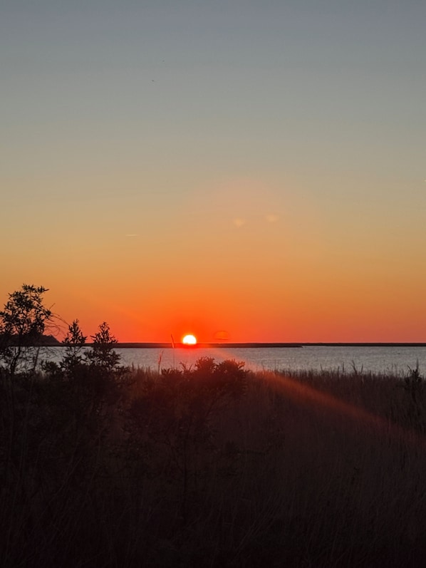 Sunset over Kitty Hawk Bay from your private deck.