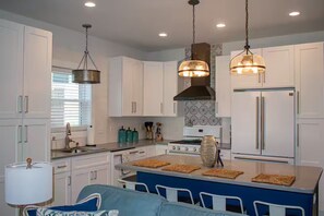 Plenty of counterspace for meal prep and a big island for everyone to assist 