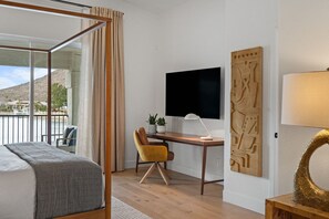 The primary bedroom suite has a large dedicated workspace and a 65" 4K TV.
