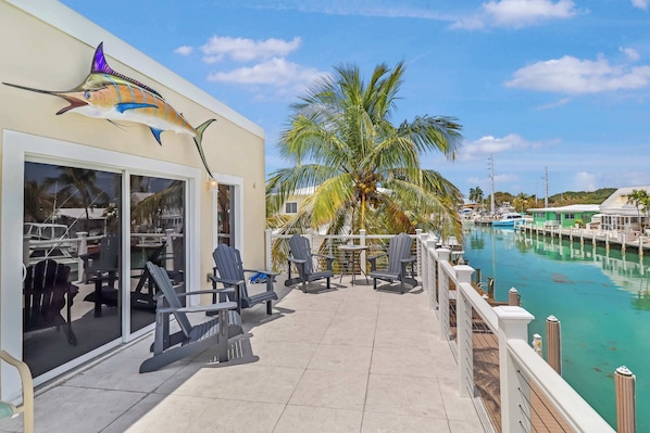 Upper deck with seating and canal, ocean views.