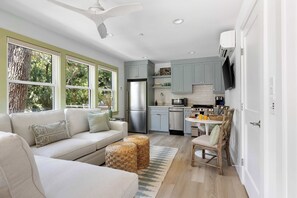 Open layout spacious living room with seating for your entire group + TV and kitchen and dining