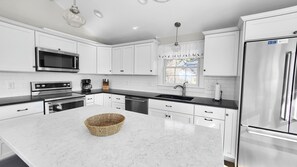 Nicely equipped kitchen with granite counter tops and stainless appliances