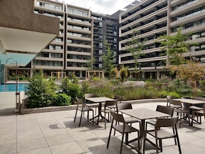 Relax in this serene outdoor space with a pool and lush gardens, perfect for unwinding after a day of adventure!
