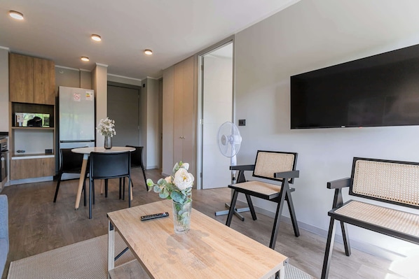 Enjoy a cozy and modern living space with a dining area, perfect for relaxation and casual meals during your stay.
