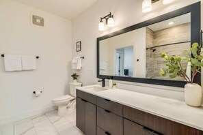 You feel a sense of calm as you enter the bathroom, where the thoughtful design and high-quality materials create a serene environment.